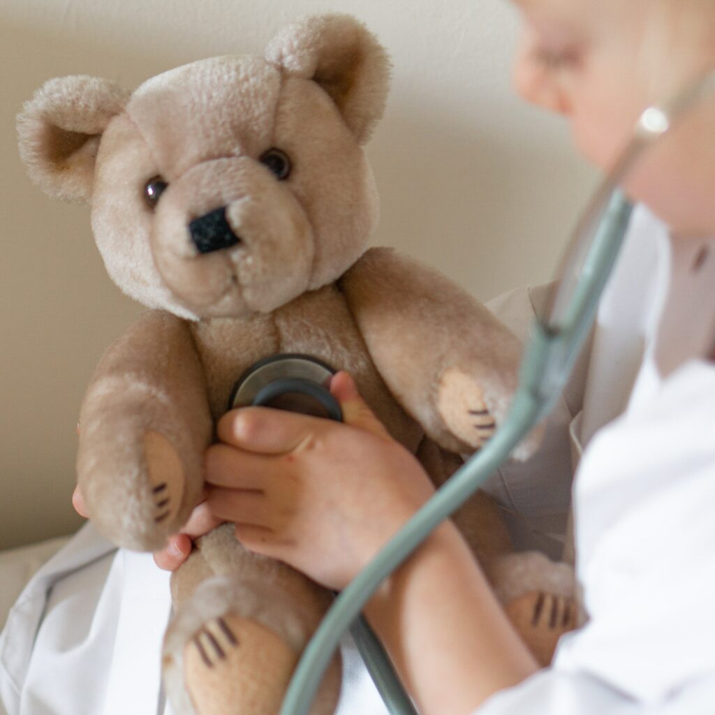 Child examining a teddy bear, to show the self-examination.